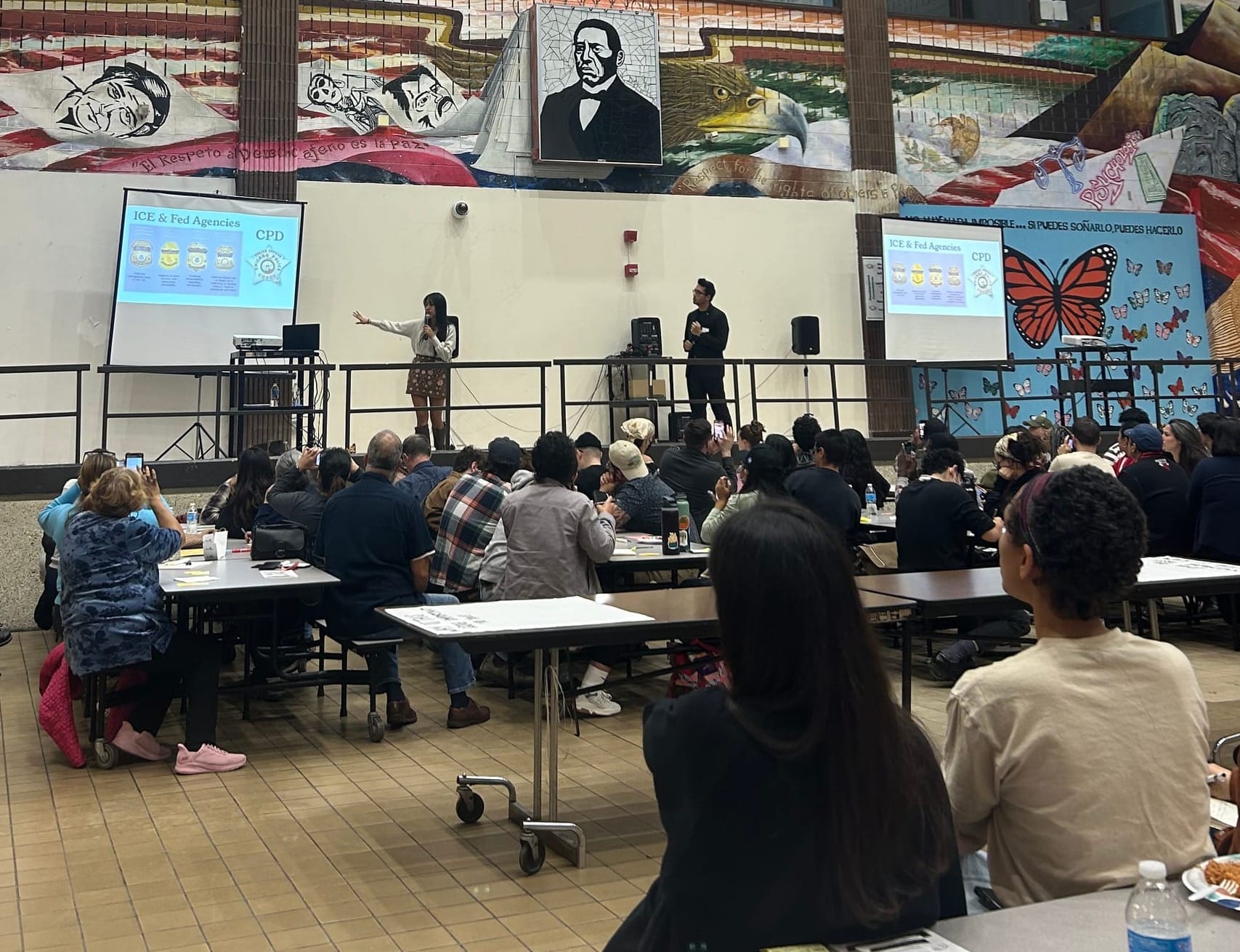 Mimi, an organizing lead with PUñO, explains how to distinguish federal agencies based on badge type | Lauren Neher/15 West