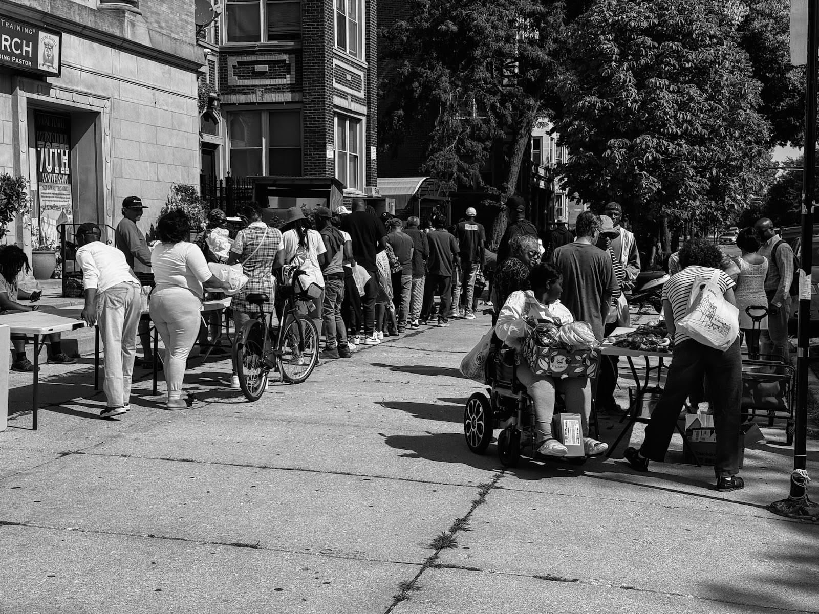 Community members line up outside Stone Temple to receive fresh produce, pantry staples, and hot meals. | Genesis Falls/15 West